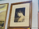 FRAMED PORTRAIT; THIS IS A FRAMED PAINTING OF A WOMAN LOOKING DOWN. THE BOTTOM HAS PRINT THAT READS