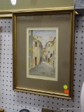 FRAMED WATERCOLOR; BEAUTIFUL WATERCOLOR OF A COBBLESTONE STREET WITH HOMES AND CLOTHES HANGING ON A