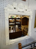 FRAMED WALL MIRROR; SQUARE MIRROR FRAMED IN CARVED WOODEN FRAME. THIS FRAME HAS FAN AND LEAF