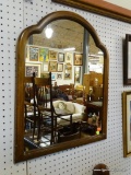 FRAMED WALL MIRROR; MEDIUM SIZED WALL MIRROR THAT IS ALMOST CLOVER SHAPED AT THE TOP. IT IS FRAMED