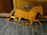HORSE WALL DECOR; WOODEN CUT OUT OF A HORSE RUNNING. THIS PIECE HAS METAL WALL HANGERS ON THE BACK.