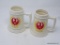 RUGER PORCELAIN STEINS; TOTAL OF 2. EACH HAS THE RED EAGLE LOGO SURROUNDED BY YELLOW WREATH PATTERN