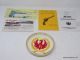 RUGER PORCELAIN ASHTRAY; WHITE PORCELAIN ASHTRAY IS ROUND AND HAS THE RED BIRD-LIKE RUGER SYMBOL