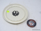 RUGER PORCELAIN ASHTRAY; WHITE PORCELAIN ASHTRAY IS ROUND AND HAS THE BLACK BIRD-LIKE RUGER SYMBOL