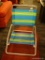 FOLDING BEACH CHAIR; THE ORIGINAL DEBRO BEACH CHAIR HAS STRIPED MESH SEAT AND BACK AND ALUMINUM