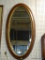 (WALL2) FRAMED MIRROR; OBLONG BEVELED GLASS MIRROR IN A WOODEN FINISH FRAME. HAS A 1 IN BEVEL.