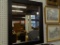 (WALL2) FRAMED MIRROR; MEDIUM SIZED MIRROR IN BLACK FRAME. MEASURES 24 IN X 29 IN