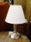 SMALL BRUSHED SILVER COLORED LAMP WITH WHITE LAMPSHADE; MEASURES 17 IN TALL.