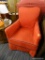 RED ARMCHAIR WITH NAVY BLUE TRIM; SOLID VIBRANT RED WITH DARK BLUE PIPED TRIM. PETITE DESIGN, SITS