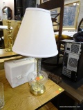 GLASS BASE TABLE LAMP WITH WHITE FAN SHAPED LAMPSHADE AND LOOP FINIAL ON TOP; STANDS ABOUT 21 IN