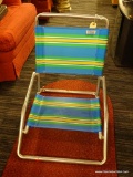 FOLDING BEACH CHAIR; THE ORIGINAL DEBRO BEACH CHAIR HAS STRIPED MESH SEAT AND BACK AND ALUMINUM