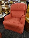 RED UPHOLSTERED RECLINING ARMCHAIR; PILLOW BACK DESIGN WITH PLEATED ARMS, COVERED IN A RED LATTICE
