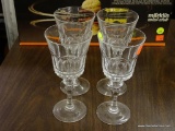 CRYSTAL WINE STEMS; 4 STEMMED GLASSES WITH A THUMBPRINT DESIGN OVER A ROPED PATTERN AND CUT STEMS.