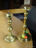 BRASS CANDLESTICKS; TOTAL OF 2 IN THIS LOT, SMALL AND LARGE (TALLER), BOTH TURNED AND ON ROUND