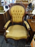VINTAGE VICTORIAN ARMCHAIR; CARVED WOOD FRAME HAS A FLOWER DESIGN ACROSS THE TOP RAIL, WITH ROUND,