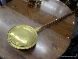 BED WARMER; VINTAGE BRASS AND MAHOGANY BED WARMER WITH STAMPED FLORAL DESIGN. MEASURES 44.5 IN LONG.