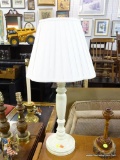 WHITE TABLE LAMP; WITH TURNED POST, ROUND BASE, AND FOLDED LAMP SHADE WITH SCALLOPED LOWER EDGE.