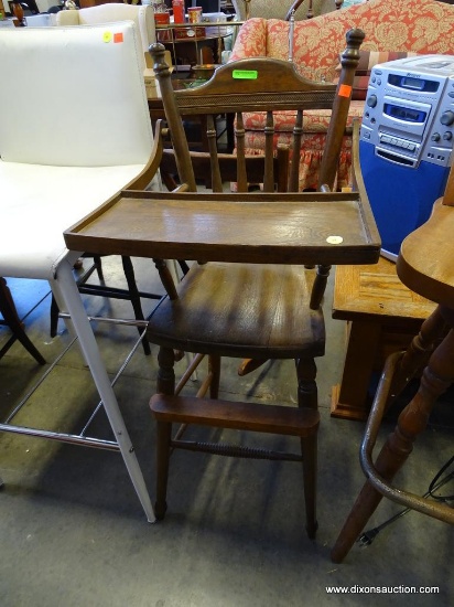 (R2) HIGH CHAIR; VINTAGE OAK HIGH CHAIR WITH SPINDLE BACK AND LIFTABLE TRAY. MEASURES 17 IN X 17 IN