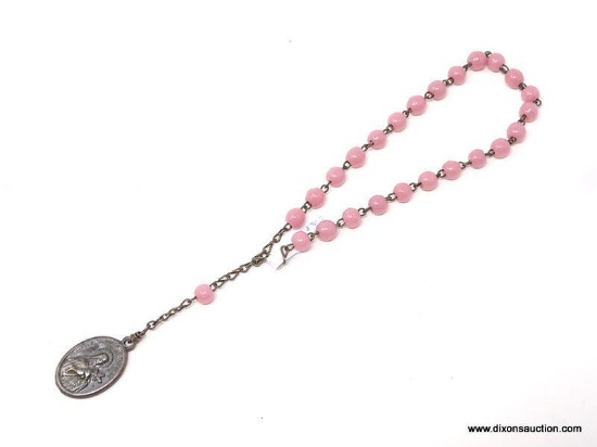 TRAVEL ROSARY WITH ROSY PINK ROUND BEADS; HAS A MEDAL OF ST THERESE OF LISIEUX AT THE END OF THE