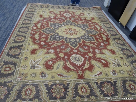 HAND KNOTTED ORIENTAL RUG FROM INDIA WITH A CENTER MEDALLION. IN BURGUNDY WITH A BLUE AND TAN