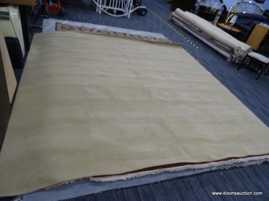 LARGE BEIGE CARPET. HAS A BERBER STYLE DESIGN. MEASURES 10 FT 4 IN X 10 FT 4 IN