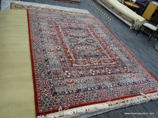MACHINE MADE 100% WOOL 8 FT X 11 FT ORIENTAL STYLE RUG. IN REDS, BLUES, AND IVORIES.