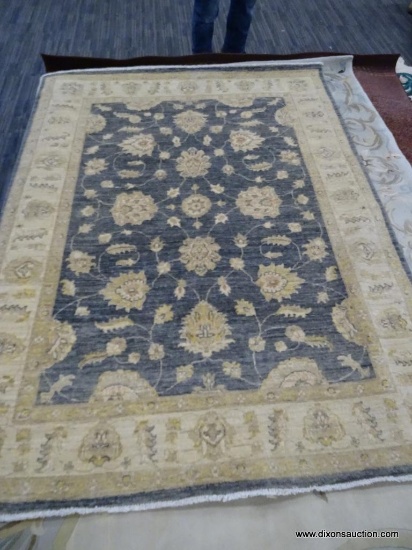 ORIENTAL STYLE AREA RUG. IN BEIGE, BLUES, AND IVORIES. MEASURES 6 FT 10 IN X 5 FT 2 IN