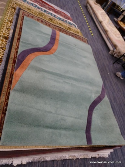 SIGNATURE RUG "NEW WAVES". IS PURPLE, ROSE, AND SEAFOAM GREEN. MEASURES 5 FT 2 IN X 7 FT