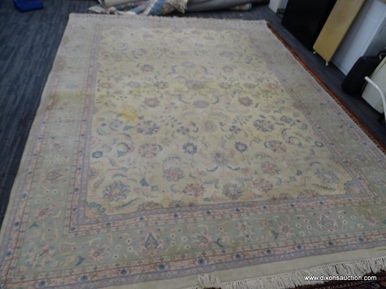 HAND KNOTTED ORIENTAL AREA RUG WITH SOME STAINING. IS IN PASTEL GREENS, YELLOWS, AND PINKS. MEASURES