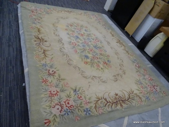 HOOK RUG WITH GREEN BACKGROUND, IVORY CENTER, RED AND TAN FLORAL DESIGN. HAS SOME SLIGHT STAINING.