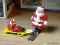 (CNTR) LEAD SANTAS; PAIR OF LEAD FIGURINES DEPICTING SANTA (1 SKIING AND 1 SLEDDING)