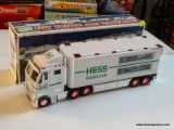 HESS TOY TRUCK AND RACE CARS; 1 OF A PAIR OF TOY TRUCKS WITH INDY STYLE RACE CARS. IN THE ORIGINAL