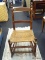 ROCKING CHAIR WITH WOVEN REED SEAT; HAS ROUNDED CORNER EARS AND 2 FLAT BACK SUPPORT RUNGS. DOUBLE