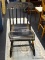 BLACK WOODEN TOLE PAINTED ROCKING CHAIR; VINTAGE ROCKING CHAIR WITH TOLE PATTERNED ROUNDED CREST