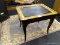 BLACK FRENCH STYLE END TABLE; RECTANGULAR SHAPED WITH ROUNDED CORNERS AND WOOD GRAIN BORDER AROUND