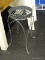 METAL PLANT STAND; GREY METAL PLANT STAND WITH METAL RING AROUND THE TOP WITH BLACK FLORAL