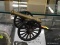 (DIS) MINIATURE CAST IRON AND BRASS CANNON; MEASURES 8.5 IN LONG WITH A PAIR OF 3.5 IN WHEELS AT