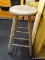 PRIMITIVE WOODEN BAR STOOL; TALL WOODEN BAR STOOL WITH ROUND SEAT AND BRACE CYLINDRICAL LEGS. THIS