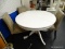 WHITE TABLE DINING WITH 4 CHAIRS; ROUND WHITE DINING TABLE SITTING ON A PEDESTAL BASE WITH 4 SPIDER