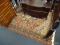 RUST/BLUE/TAN FRINGED AREA RUG; REDDISH COLORED BODY OF RUG WITH FLORAL BORDER AS WELL AS CENTER