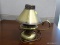 SMALL BRASS CANDLESTICK LAMP; METAL FAN SHAPED LAMPSHADE PERCHES ATOP BULB NESTLED INTO A