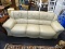 TAN LEATHER SOFA; 3 CUSHION OVERSTUFFED LEATHER SOFA IN CREAM COLOR. MEASURES 88 IN X 34 IN X 38 IN.