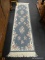 FRINGED HALLWAY RUNNER RUG; MACHINE WOVEN, LIGHT BLUE WITH CREAM COLORED TRIM AND FRINGE AND PINK