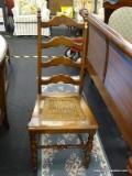 LADDERBACK WOODEN SIDE CHAIR WITH CANE SEAT; TURNED FINIALS AT TOP CORNER WITH 4 SCALLOPED CARVED