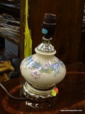 FLORAL TABLE LAMP; CREAM COLORED TABLE LAMP WITH PINK AND BLUE FLORAL PATTERN AROUND THE BASE. DOES