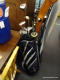 NIKE GOLD BAG AND CLUBS; BLACK, WHITE, AND NAVY NIKE GOLF BAG. THIS BAG HAS 5 ZIPPERED POCKETS, A