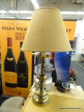 BRASS TABLE LAMP; BRASS TABLE LAMP WITH BURLAP BELL SHAPED SHADE SITTING ATOP A A TURNED LOOK BRASS