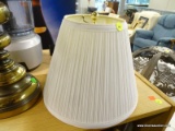 WHITE LAMPSHADE; MEDIUM SIZED WHITE PLEATED BELL SHAPED LAMP SHADE. MEASURES 9 IN X 12 IN DIAMETER.
