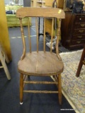 PRIMITIVE SIDE CHAIR; THIS CHAIR HAS A CURVED TOP RAIL, TURNED SUPPORT RAILS, A ROUND SEAT, FRONT