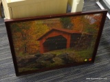 COVERED BRIDGE FRAMED PUZZLE; THIS FRAMED PUZZLE IS OF A RED COVERED BRIDGE WITH ROCKS IN THE